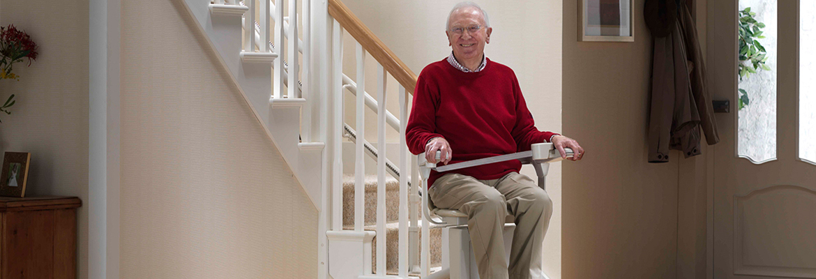 Curved Stair Lift near syracuse ny image of Elderly Person Riding a curved stair lift From Syracuse Elevator